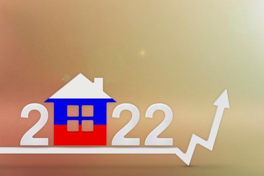 The cost of real estate in Russia in 2022. Rising cost of construction, insurance, rent in Russia. 3d House model painted in flag colors, up arrow on yellow background.