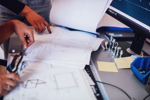Engineer technician designing drawings mechanical parts engineering Engine.manufacturing factory Industry Industrial work project blueprints measuring bearings caliper tools. High quality photo