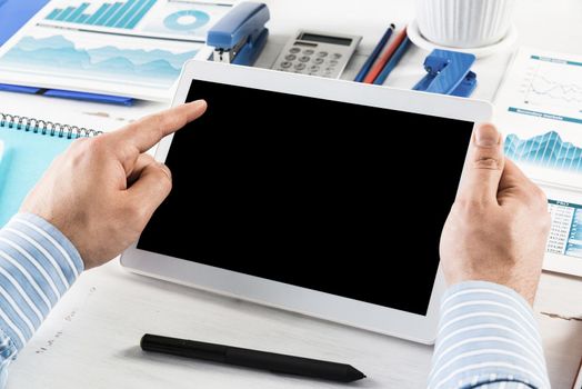 close-up of men's hands with a computer tablet. Businessman works in the office