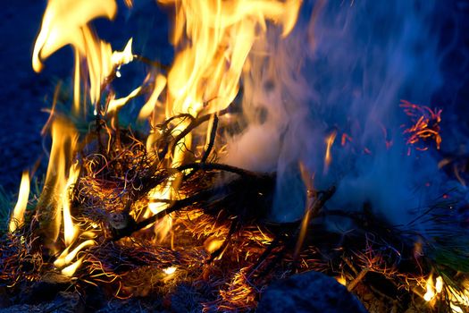 a large open-air fire used as part of a celebration, for burning trash, or as a signal.