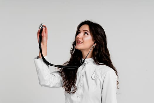 Doctor in medical robe with stethoscope at coronavirus covid-19 period. Nurse in white medical dress on white background