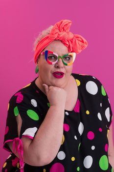 Happy Plus Size Woman Wearing Eyeglasses Smiling To Camera Standing Over Pink Background. Cheerful Millennial Female In Eyewear Posing In Studio. High quality photo