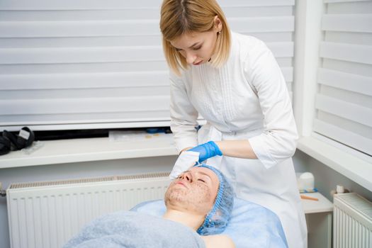 Skin cleaning by a beautician. Cosmetological procedures for women. Rejuvenating effect of dermatologist procedures