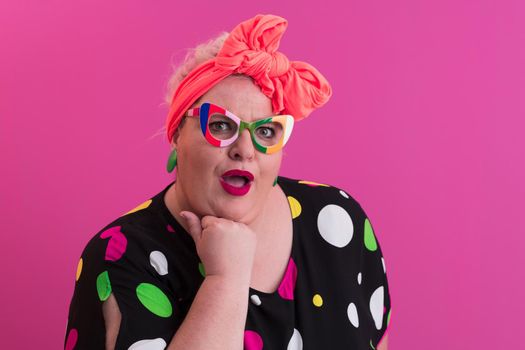 Happy Plus Size Woman Wearing Eyeglasses Smiling To Camera Standing Over Pink Background. Cheerful Millennial Female In Eyewear Posing In Studio. High quality photo