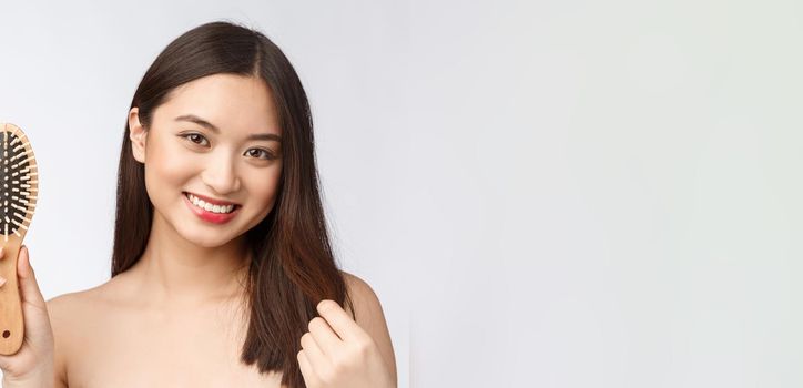 portrait of a beautiful young woman comb wonderful hair isolated on white background, asian beauty.