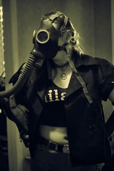 girl in a gas mask with a hose
