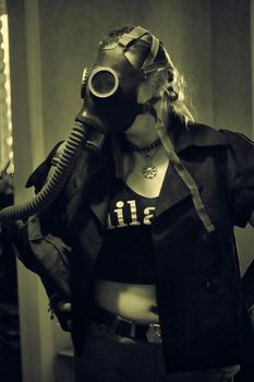 girl in a gas mask with a hose