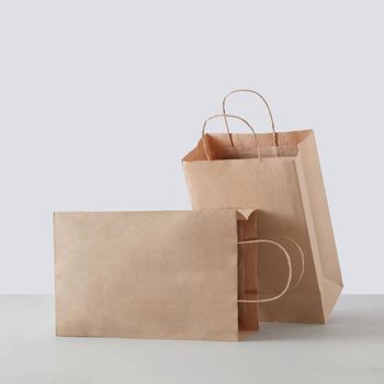 Two paper carton bags for commercial shopping in the store. Mockup for business or delivery.