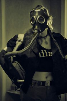 girl in a gas mask with a hose