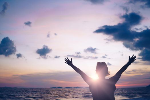 Woman rise hand to sky show freedom and travel around the world with summer beach relax life concept.