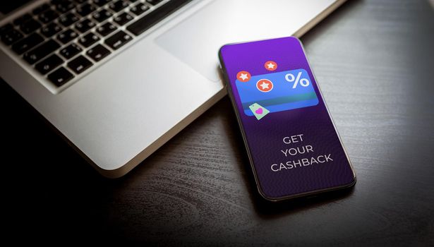 Cashback loyalty program concept. Customer rewards and money refund service. Smartphone with discount card with rewarding marketing points on the screen and text get your cashback. High quality photo