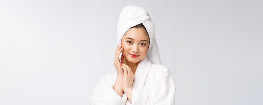 Spa skincare beauty Asian woman drying hair with towel on head after shower treatment. Beautiful multiracial young girl touching soft skin