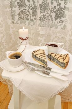 German poppy seed cake on white plate with chocolate and coffee