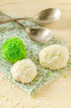 Tree cookies with coconut flakes on cotton cloth. Near spoons.
