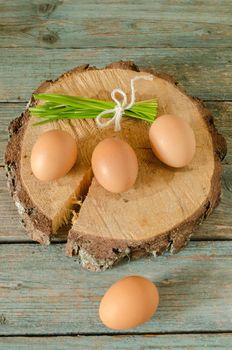 Easter still life with eggs on cut tree. Rustic style.