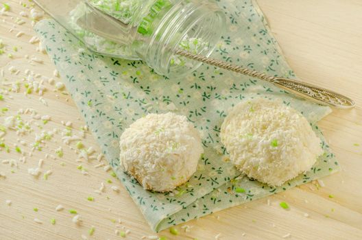 Twoo cookies with coconut flakes on cotton cloth. Near glass jar. Overhead view