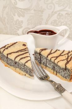 German poppy seed cake on white plate with chocolate and coffee