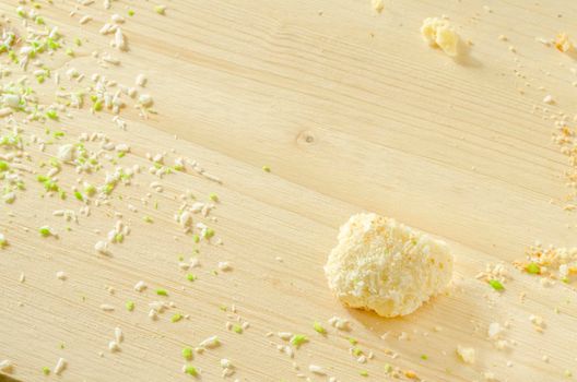 White wooden background with sugar cookie crumbs and coconut flakes Best for desing of menu, baking recipes
