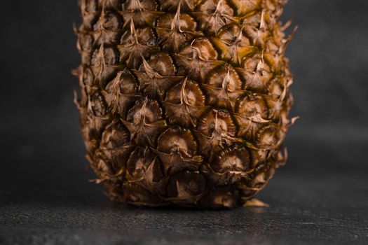 Close-up pineapple tropical fruit on dark stone background background. Citrus fruit with vitamin c for helth care