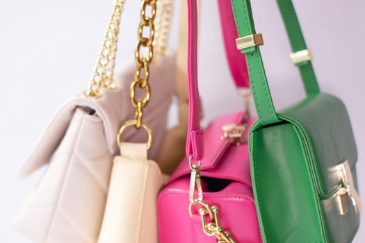 woman hand holding set of colorful bags. Product composition photography. handbag and purse for women.