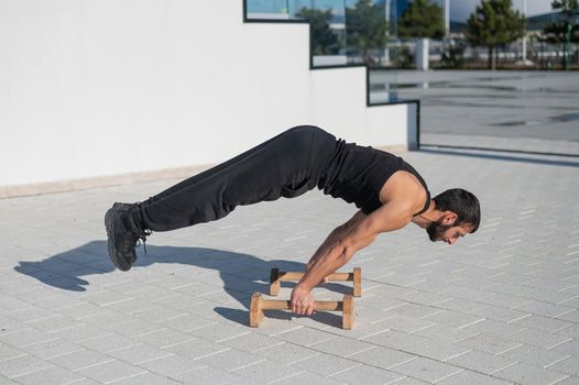 Man doing balance exercise on floor bars for fitness