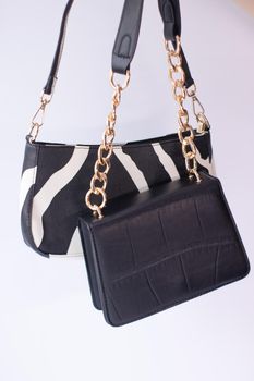 close up of womans hand holding fashionable little black bag. Product photography. stylish handbag and purse for women.