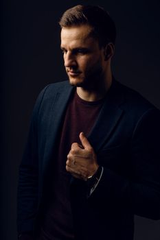 Business man portrait on dark background. Handsome young man weared suit in studio. Confident professional fashion male posing in studio.