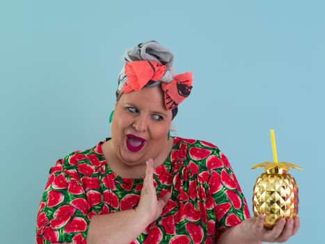 Overweight plus size female, fat women, Fat girl, Chubby, holding golden fruit ananas isolated on cyan background - lifestyle Woman diet weight loss overweight problem concept. High quality photo