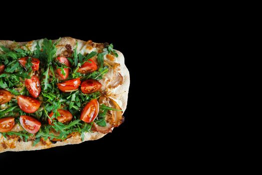 Pinsa romana gourmet italian cuisine on black background. Scrocchiarella. Pinsa with meat, arugula, tomatoes, cheese