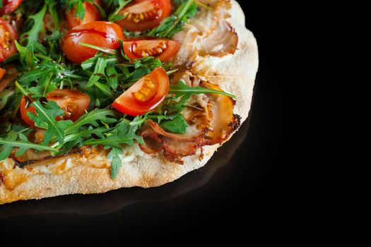 Pinsa romana gourmet italian cuisine on black background. Scrocchiarella. Pinsa with meat, arugula, tomatoes, cheese