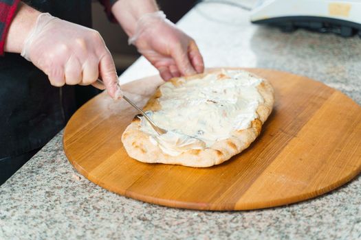 Dough for pinsa romana with cheese sauce. Scrocchiarella gourmet italian cuisine. Traditional dish