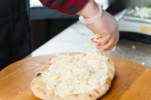 Dough for pinsa romana with cheese sauce. Scrocchiarella gourmet italian cuisine. Traditional dish