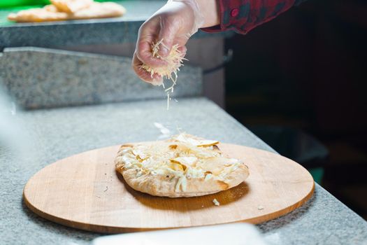 Dough for pinsa romana with cheese sauce. Scrocchiarella gourmet italian cuisine. Traditional dish