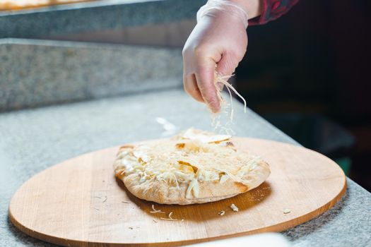 Dough for pinsa romana with cheese sauce. Scrocchiarella gourmet italian cuisine. Traditional dish