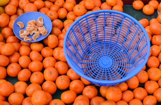 Mandarins on the market Plate with mandarin slices for tasting