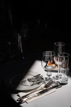 Glasses, plate and cutlery on the table. Table setting in the restaurant