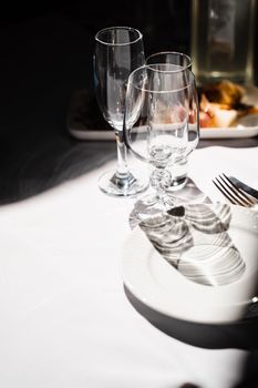 Glasses, plate and cutlery on the table. Table setting in the restaurant