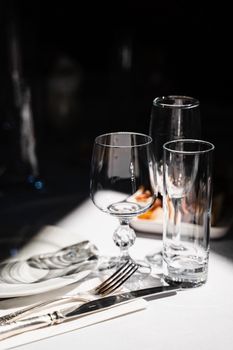 Glasses, plate and cutlery on the table. Table setting in the restaurant