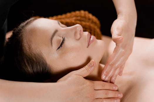 Neck and face massage in the spa. Beauty treatments for an attractive female model. Relaxation