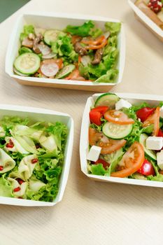 Green natural salads in eco thermo box with microgreen, veal, cucumber, tomato, cheese. Safety delivery at quarantine covid 19.