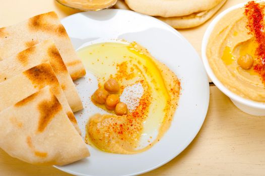 traditional chickpeas Hummus with pita bread and paprika on top 