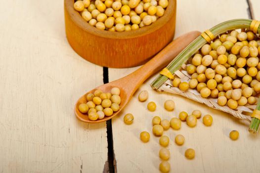 organic soya beans over rustic wood table macro closeup