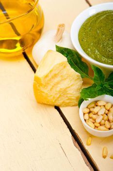 Italian traditional basil pesto sauce ingredients on a rustic table