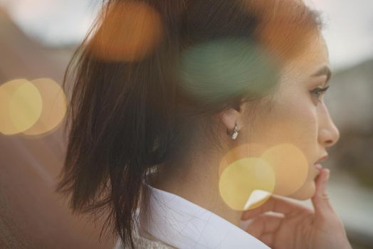 Outdoor portrait of a young beautiful fashionable lady wearing stylish coat . Model looking aside. Female fashion concept. City lifestyle. Close up. big plump lips