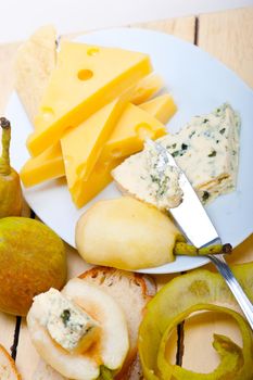 selection of different cheese and fresh pears appetizer snack 