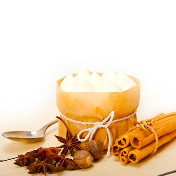 fresh vanilla and spice cream cake dessert over a rustic white wood table