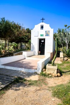 Santa Pola, Alicante, Spain- May 6, 2022: Facade of the Hermitage of Santa Pola Lighthouse seascape under blue sky