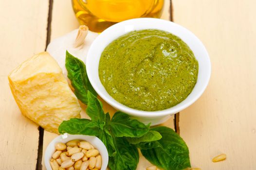 Italian traditional basil pesto sauce ingredients on a rustic table