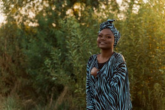 Happy muslim girl in trendy traditional clothes smiles. Woman in traditional blue hijab. Cultures of the all of the world. African people lifestyle