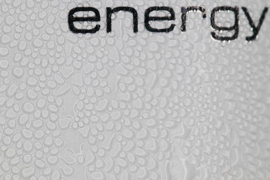 Cooling wet condensation water droplets on white aluminum surface with energy word text print